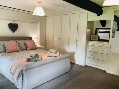 a bedroom with a bed with two towels on it at Cobblers Cottage in Brecon Beacons in Brecon