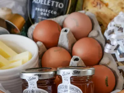 a basket of eggs and honey and some cheese at Grove Farm Cottage in Condover