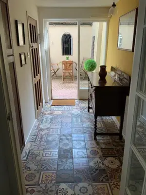 a hallway with a tile floor and a room with a table at Magical period house in the heart of Ludlow - Pass the Keys in Ludlow