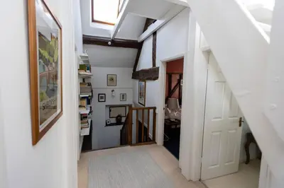 an attic hallway with a white door and a stairway at Magical period house in the heart of Ludlow - Pass the Keys in Ludlow
