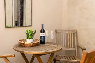 a table with a bottle of wine and two glasses at Magical period house in the heart of Ludlow - Pass the Keys in Ludlow