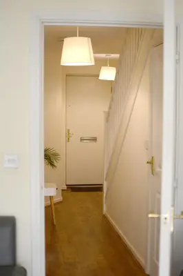 an empty hallway with a white door and a staircase at Family home close to Shrewsbury Town centre in Shrewsbury