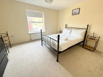 a bedroom with a bed and a window at Family home close to Shrewsbury Town centre in Shrewsbury