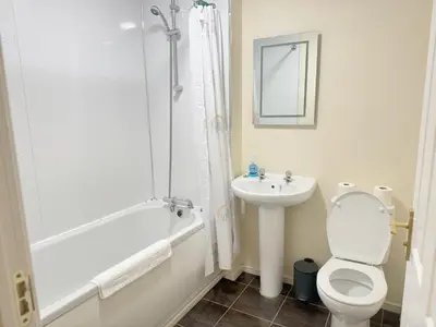 a bathroom with a toilet and a sink at Family home close to Shrewsbury Town centre in Shrewsbury