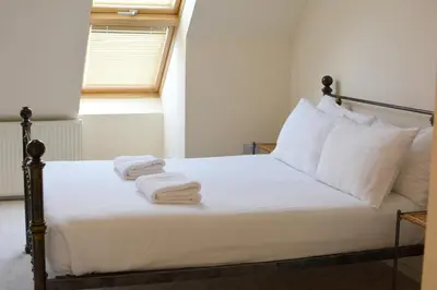 a bedroom with a bed with towels on it at Family home close to Shrewsbury Town centre in Shrewsbury