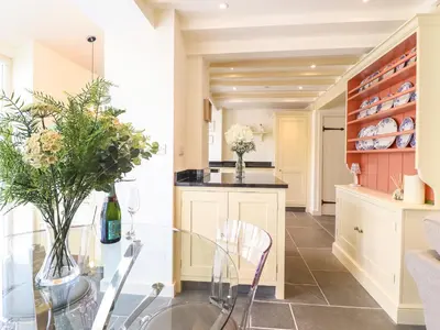 a dining room and kitchen with a glass table at Tan Y Ddol in Welshpool
