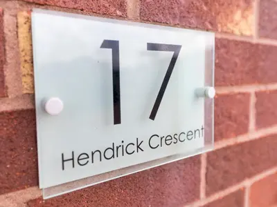a sign on a brick wall with at Stylish modern two bedroom home in Shrewsbury - Pass the Keys in Shrewsbury