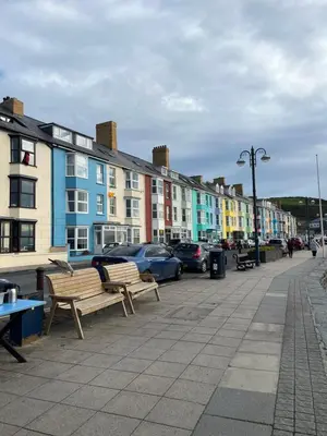 a row of colorful buildings on a city street at Seafront apartment with balcony, parking and sea views in Aberystwyth