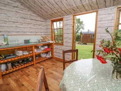 a room with a table and a counter with a window at Tilly Gypsy-style Caravan Hut in Brecon