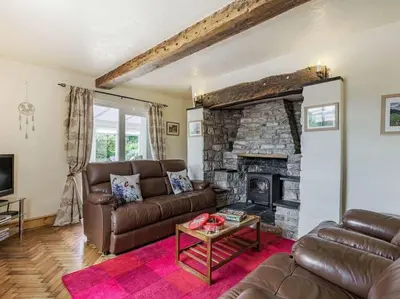 a living room with a couch and a fireplace at 18th Century Farmhouse, England Wales Border, Breathtaking Views in Oswestry