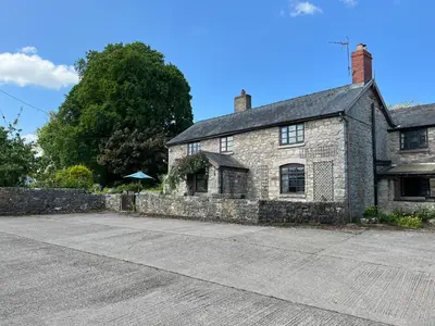 an old stone house with a large driveway at 18th Century Farmhouse, England Wales Border, Breathtaking Views in Oswestry