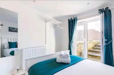 a bedroom with a bed with towels on it at The Cwtch in Brecon
