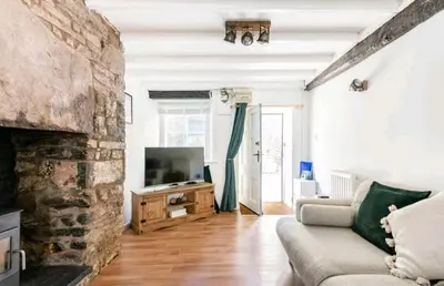 a living room with a couch and a fireplace at The Cwtch in Brecon