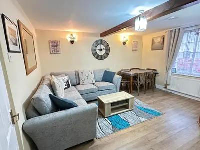a living room with a couch and a table at Llanidloes Townhouse-pet-friendly-sleeps 7-Mid Wales in Llanidloes