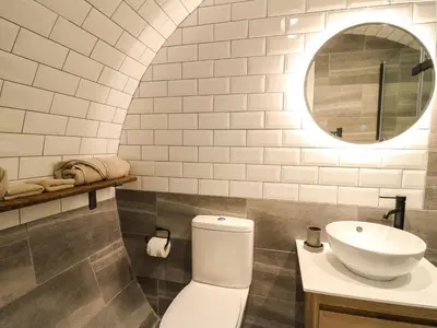 a bathroom with a white toilet and a sink at Tan Y Wawr - Derwen in Welshpool