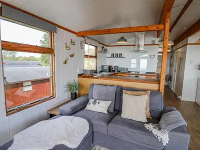 a living room with a couch in a tiny house at Top Of The World Lodge in Aberdyfi