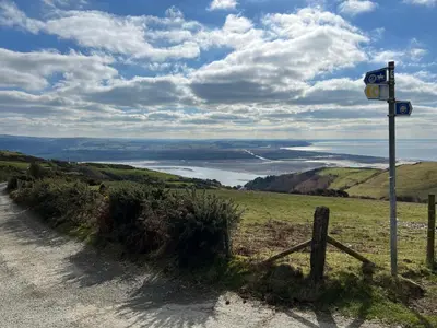 a road with a sign on the side of a hill at Top Of The World Lodge in Aberdyfi