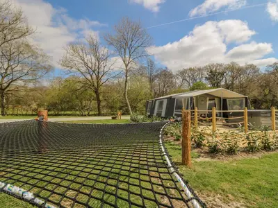 a trailer and a tent in a field at The Salmon in Rhayader
