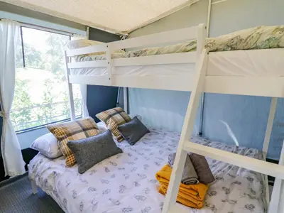 a bedroom with two bunk beds and a bed at The Salmon in Rhayader