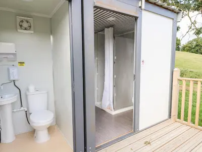 a bathroom with a toilet on a deck at The Otter in Rhayader