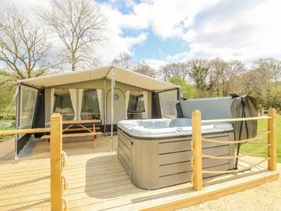 a tent with a hot tub on a deck at The Heron in Rhayader