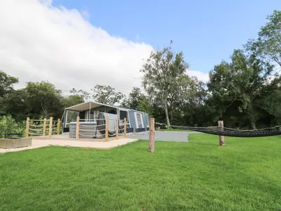 a tent in the middle of a grass field at The Kingfisher in Rhayader