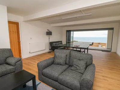 a living room with a couch and a table at Machlud Haul in Llwyngwril