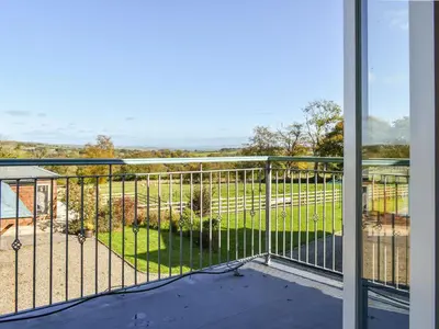 a balcony with a view of a yard at Ysgubor Blaenparc Barn - Uk41030 in Mydroilin
