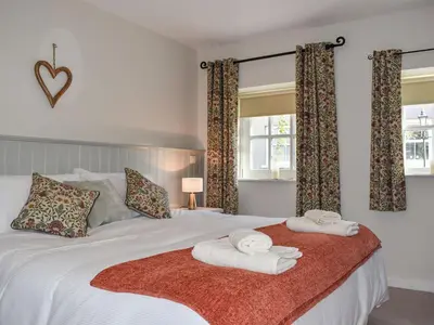 a bedroom with a bed with towels on it at Ysgubor Blaenparc Barn - Uk41030 in Mydroilin