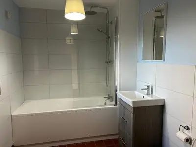 a bathroom with a tub and a sink and a shower at Owlbury Hall Barn in Montgomery