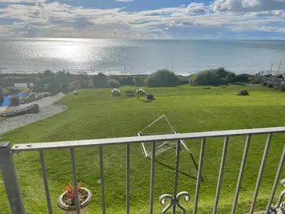 a view of the ocean from the balcony of a house at Barmouth Pet-Friendly 2-Bed Caravan with Sea View in Barmouth
