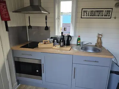 a kitchen with a sink and a counter top at Glamping Hut - Sleeps 2 hot tub & parking in Welshpool