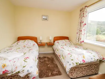 a bedroom with two beds and a window at Llwynon in Aberystwyth