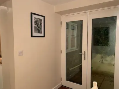 a room with a glass door with a picture on the wall at Cwmbach Cottage, Hay on Wye in Glasbury