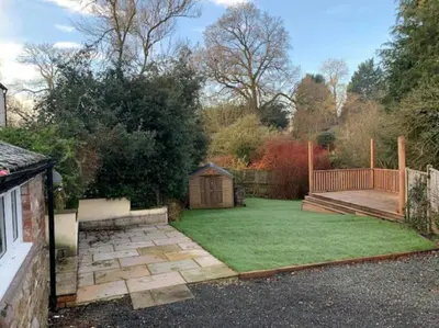 a backyard with a garden with a wooden fence at Cwmbach Cottage, Hay on Wye in Glasbury