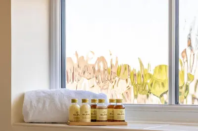 four bottles of honey sitting on a shelf in front of a window at Fair View - Off Street Parking and Garden in Shrewsbury