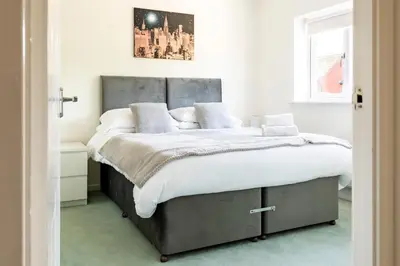a bedroom with a large bed with white sheets and pillows at Fair View - Off Street Parking and Garden in Shrewsbury