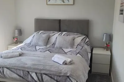 a bedroom with a bed with two towels on it at Fair Haven - Off Street Parking and Garden in Shrewsbury