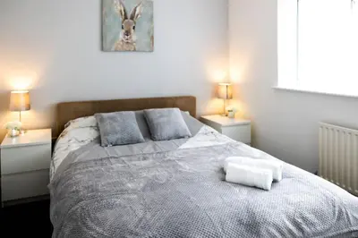 a bedroom with a large bed with two night stands at Fair Haven - Off Street Parking and Garden in Shrewsbury