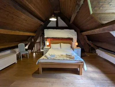 a bedroom with a large bed in a attic at Longhouse - Hen Dy in Rhayader