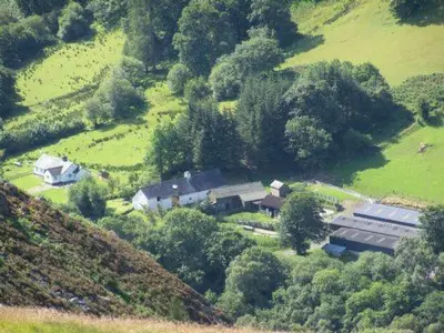 an aerial view of a house on a hill at Longhouse - Hen Dy in Rhayader