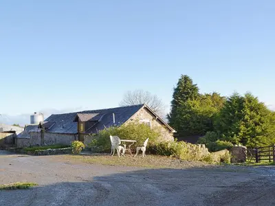 two animals standing on the side of a road at Stable Cottage in Oswestry