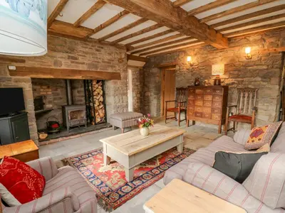 a living room with a couch and a table at Pen Bont Home Farm in Brecon
