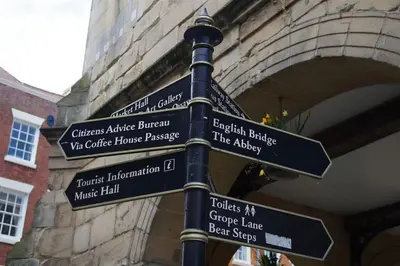 a pole with street signs in front of a building at Chandeliers 6 in Shrewsbury