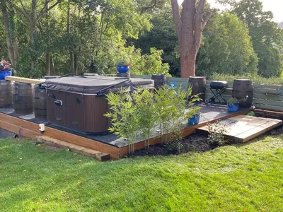 a deck with a couple of containers on it at Mountain View Cottage, Hot Tub , Stunning Views in Llanhamlach