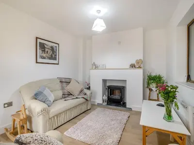 a living room with a couch and a fireplace at The Old Nursery in Sennybridge