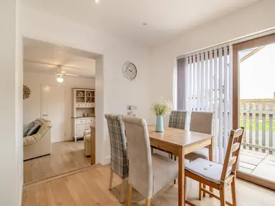 a kitchen and dining room with a table and chairs at The Old Nursery in Sennybridge