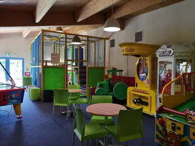 a classroom with a table and chairs and play equipment at Snowdonia Sunbeach Holiday Sea and Mountain view in Llwyngwril
