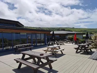 a group of picnic tables on a deck at Snowdonia Sunbeach Holiday Sea and Mountain view in Llwyngwril
