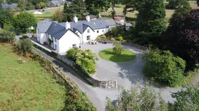 an aerial view of a house and a river at 4 Bed in Brithdir oc-wag722 in Cross Foxes